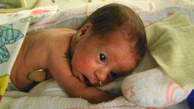 Lily on her tummy ready to go see Daddy.